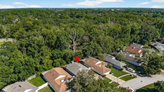 an aerial view of a houses with a yard
