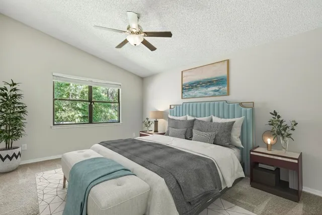 a bedroom with a bed and a chandelier