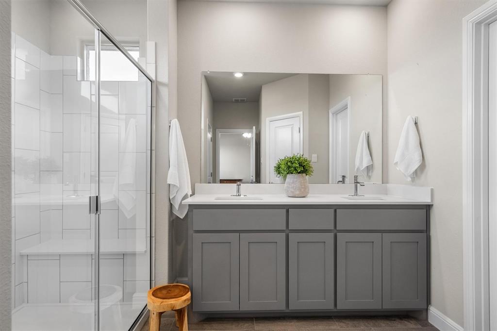 1864 Mensa Drive Haslet, TX 76052 - Photo 27 of 40 a bathroom with a double vanity sink mirror and shower