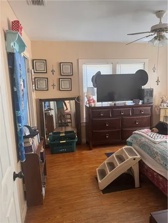 a bedroom with a bed dresser and a window