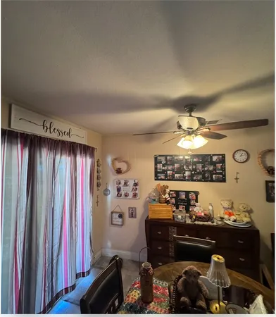 a room with furniture and view of kitchen