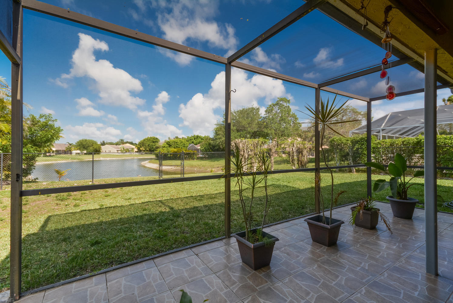 22166 Appleton Drive Boca Raton, FL 33428 - Photo 25 of 47 a view of a floor to ceiling window next to a yard