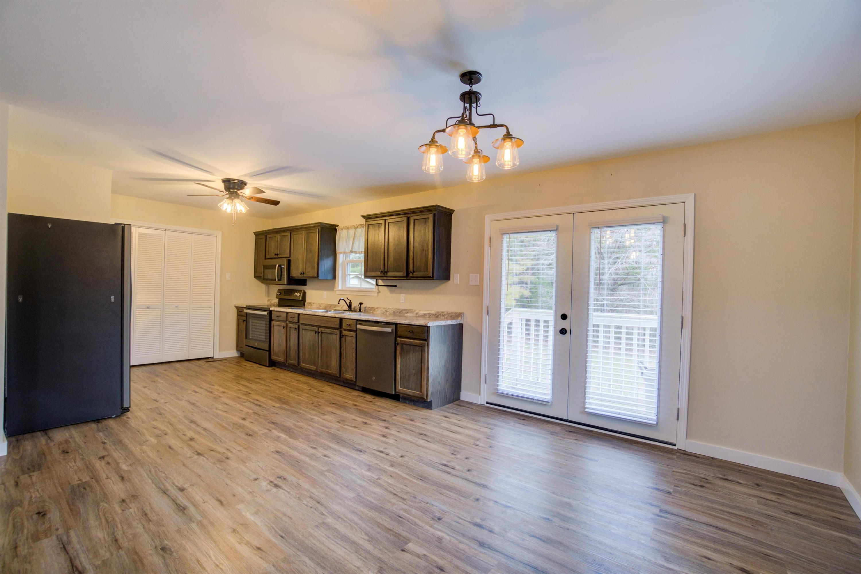 430 Teacher Road Lavinia, TN 38348 - Photo 11 of 20 a view of a kitchen with a sink and dishwasher a refrigerator with wooden floor