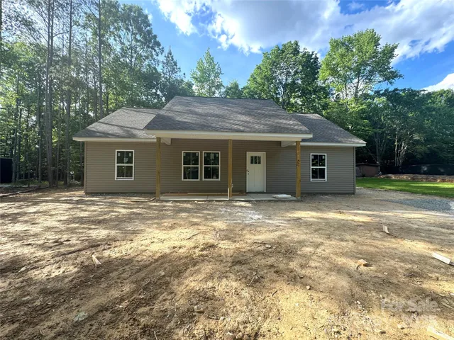 a house that has a tree in front of it