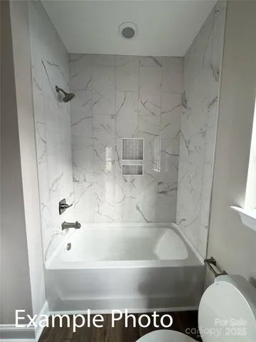 a bathroom with a shower and a toilet