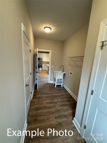 an empty room with wooden floor and window