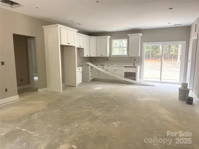 a view of kitchen with refrigerator and window