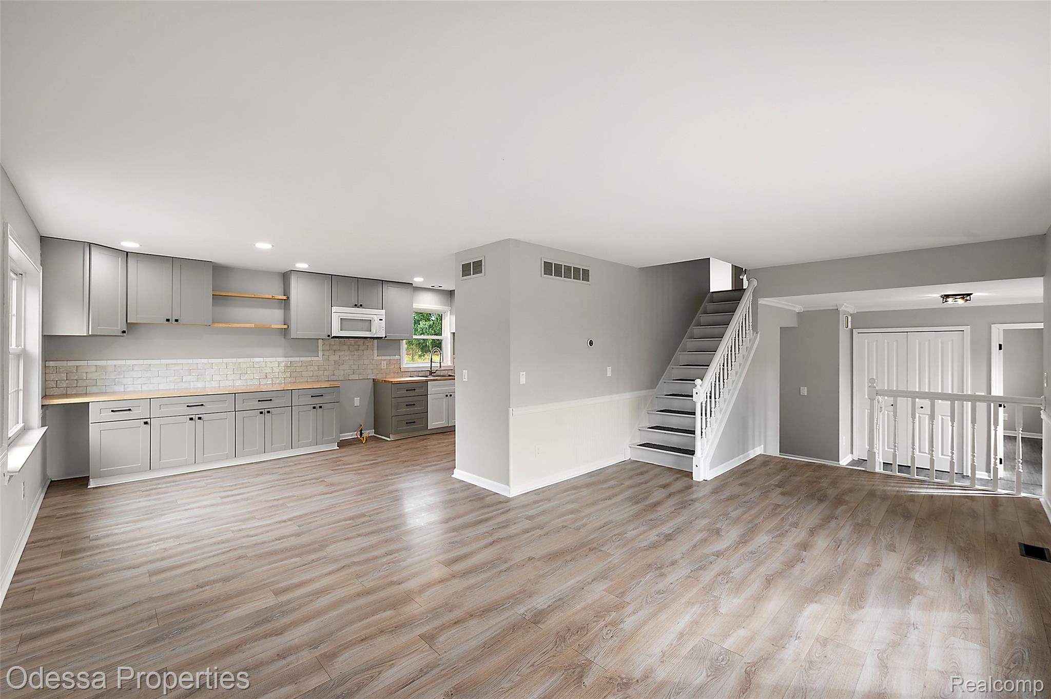 1442 Riley Center Road Memphis, MI 48041 - Photo 19 of 62 Unfurnished living room with light wood-type flooring, stairs, and recessed lighting