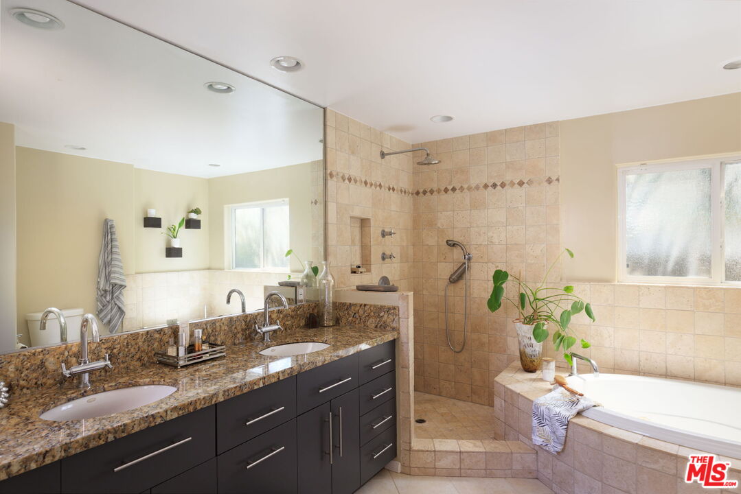 12416 Aneta Street Los Angeles, CA 90066 - Photo 11 of 22 a spacious bathroom with a granite countertop sink a toilet and a shower