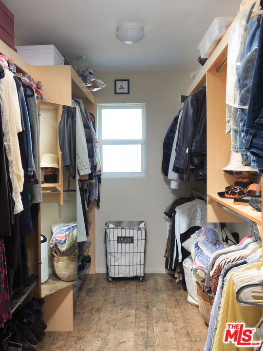 12416 Aneta Street Los Angeles, CA 90066 - Photo 12 of 22 a view of walk in closet with clothes and shoes