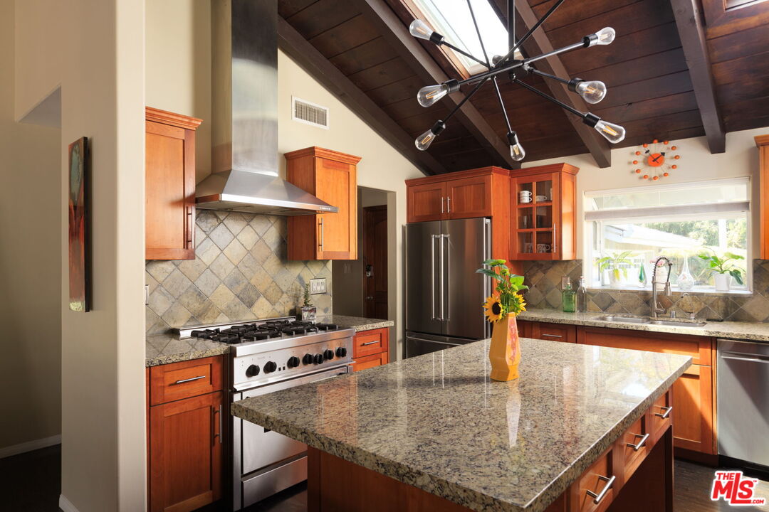 12416 Aneta Street Los Angeles, CA 90066 - Photo 3 of 22 a kitchen with stainless steel appliances granite countertop a sink a stove and a refrigerator