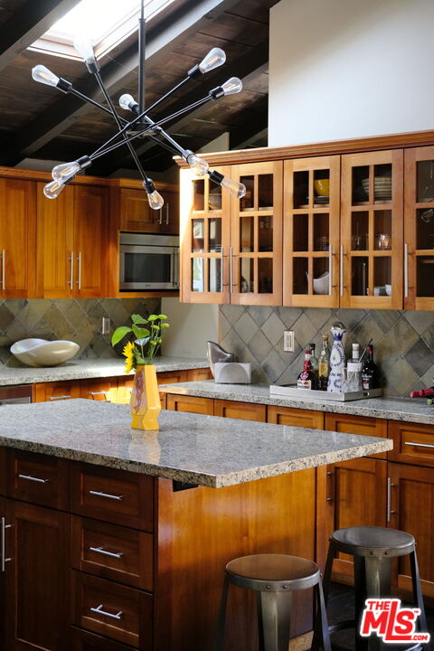 12416 Aneta Street Los Angeles, CA 90066 - Photo 4 of 22 a view of a kitchen with granite countertop a sink and a counter top space
