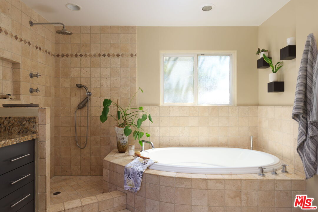 12416 Aneta Street Los Angeles, CA 90066 - Photo 10 of 22 a bathroom with a bathtub and shower