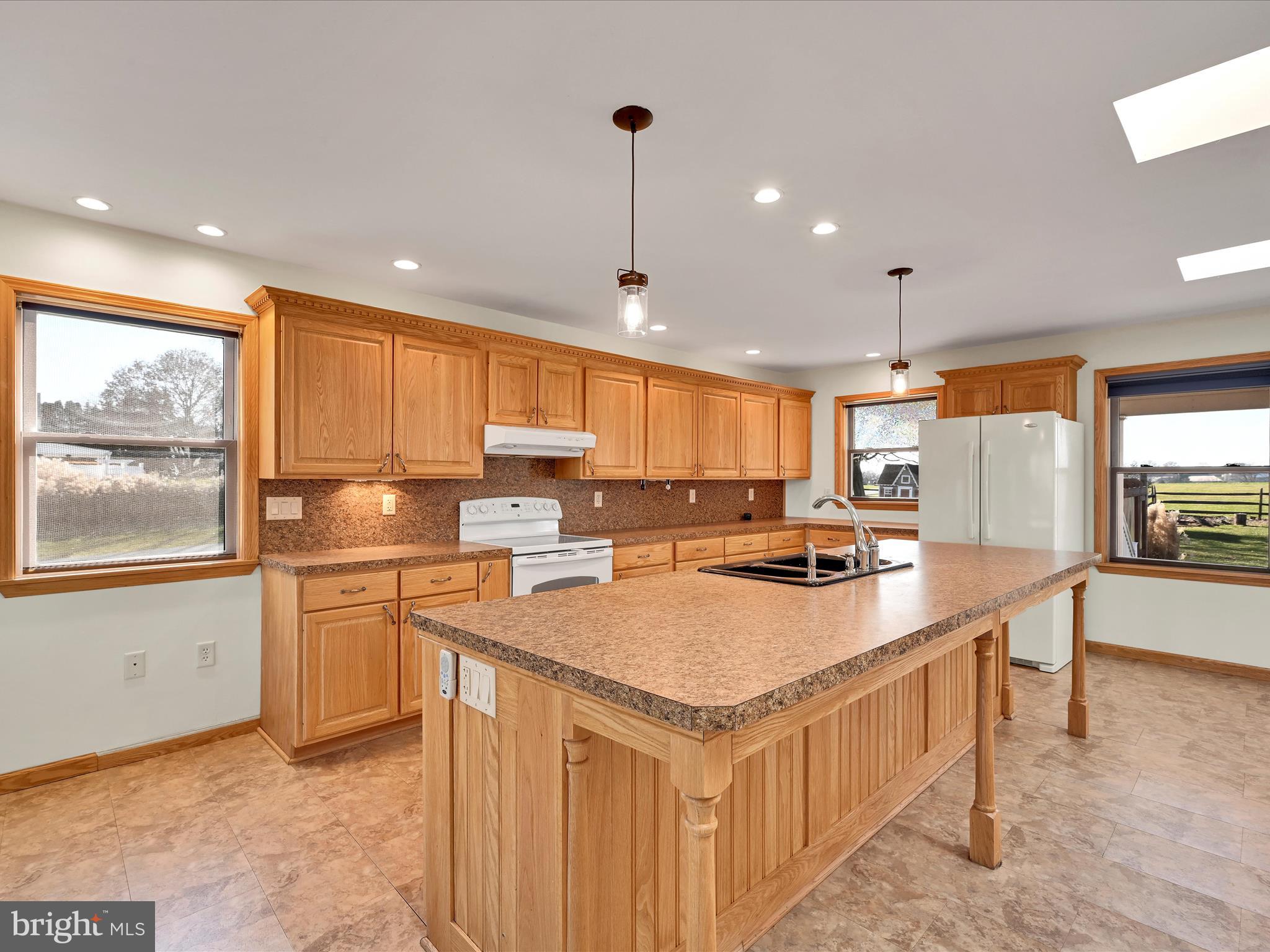 20 Bomberger Road Lititz, PA 17543 - Photo 14 of 50 a kitchen with a stove a sink a refrigerator and chairs