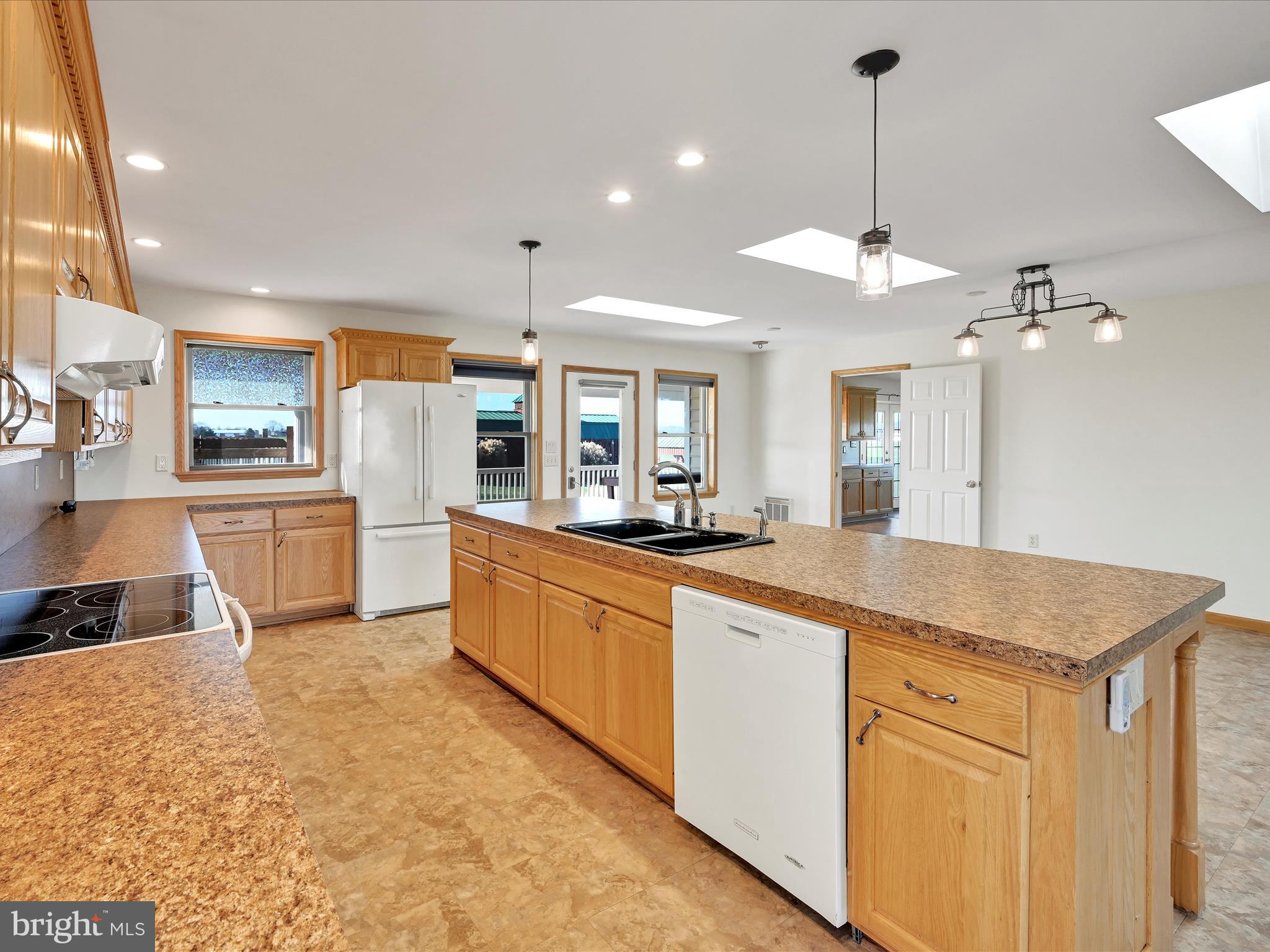 20 Bomberger Road Lititz, PA 17543 - Photo 15 of 50 a large kitchen with kitchen island a large counter space a sink appliances and cabinets
