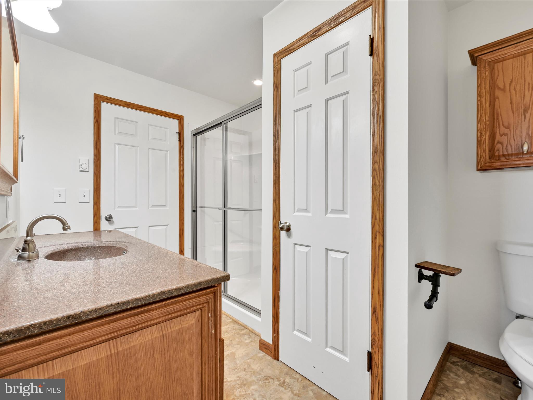 20 Bomberger Road Lititz, PA 17543 - Photo 26 of 50 a bathroom with a granite countertop sink and a mirror