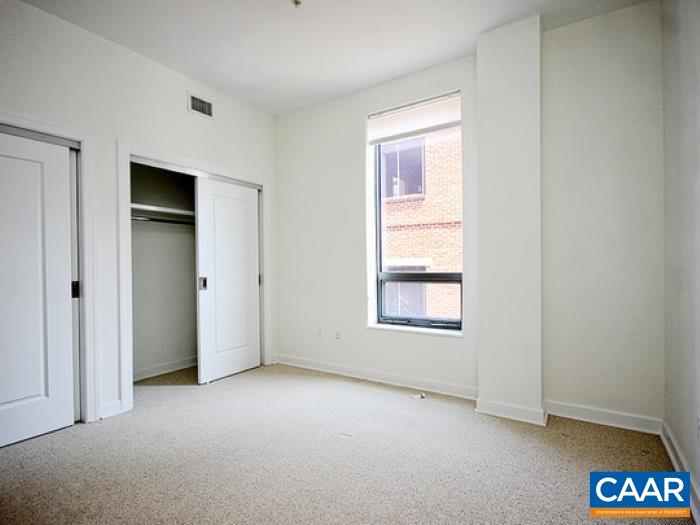 112 5th Street Southeast, Unit 3B Charlottesville, VA 22902 - Photo 8 of 9 an empty room with windows and closet