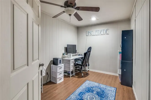 a view of a workspace with furniture and wooden floor