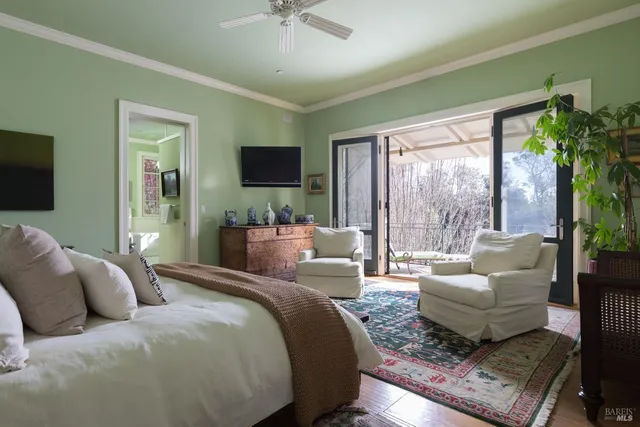 a spacious bedroom with a bed couch and a large window