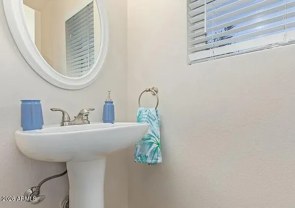 a bathroom with a sink a mirror and a shower