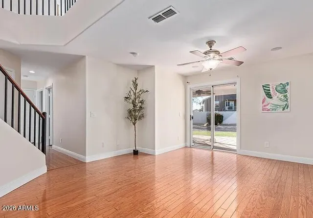 wooden floor in an empty room with a window