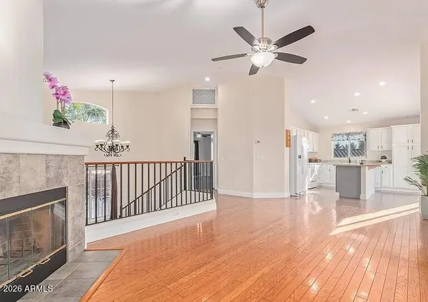 a view of a livingroom with a kitchen and a stove wooden floor