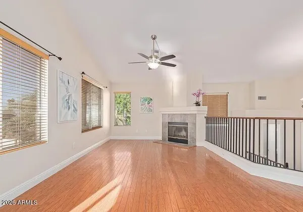 a view of an empty room with a fireplace and a window