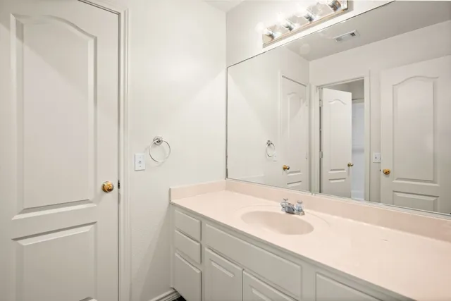 a bathroom with a sink and mirror