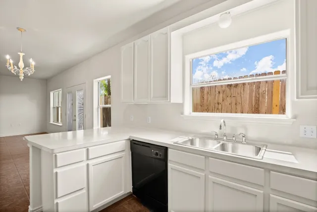 a kitchen with a sink cabinets and window