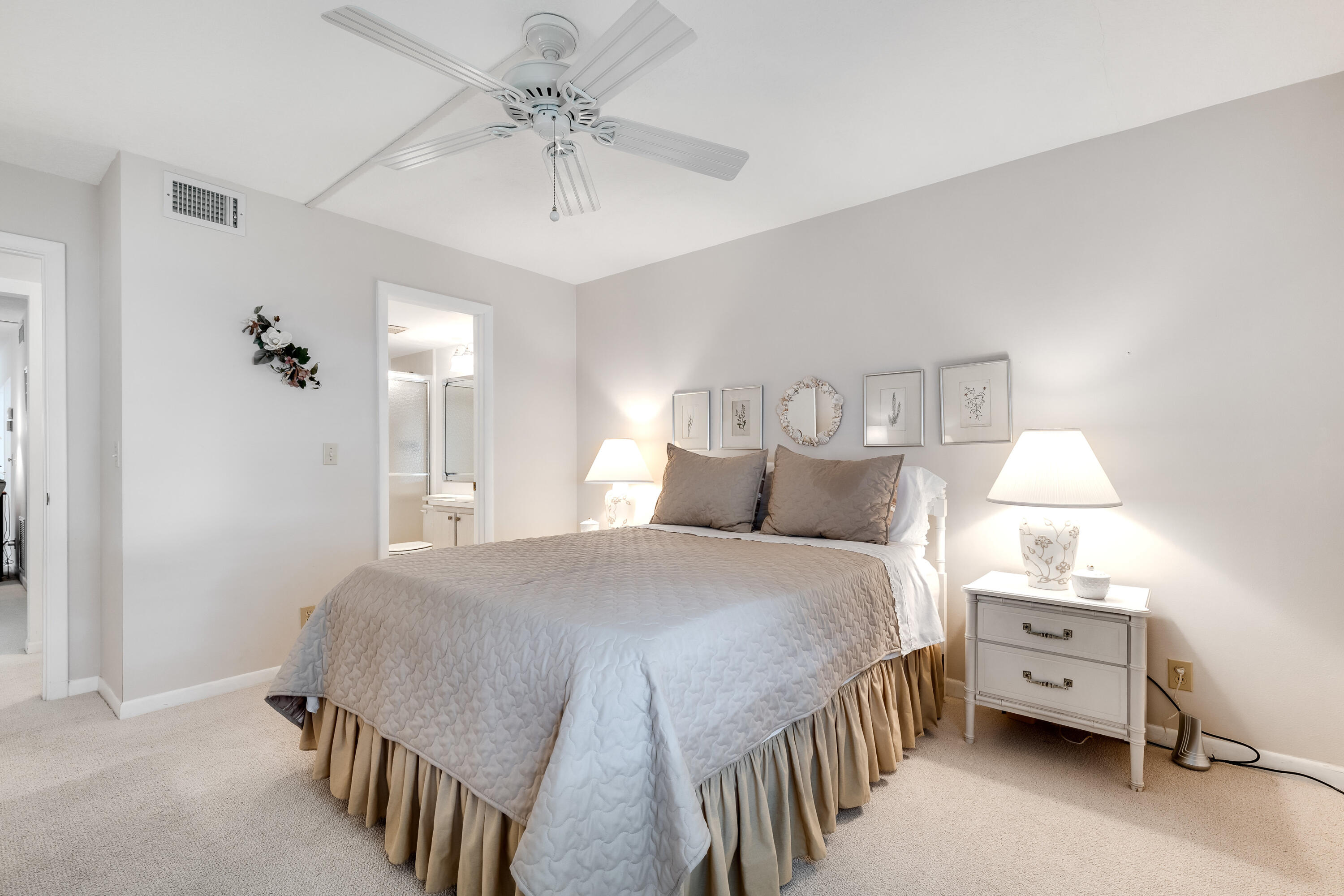 122 Lake Pine Circle, Unit B1 Greenacres, FL 33463 - Photo 20 of 36 a bedroom with a bed and a chandelier