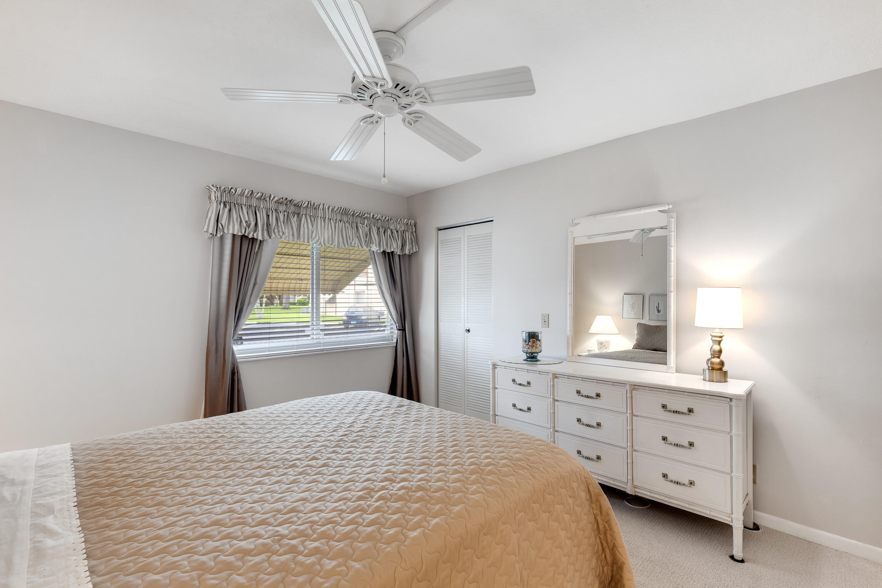 122 Lake Pine Circle, Unit B1 Greenacres, FL 33463 - Photo 22 of 36 a bedroom with a bed and a dresser