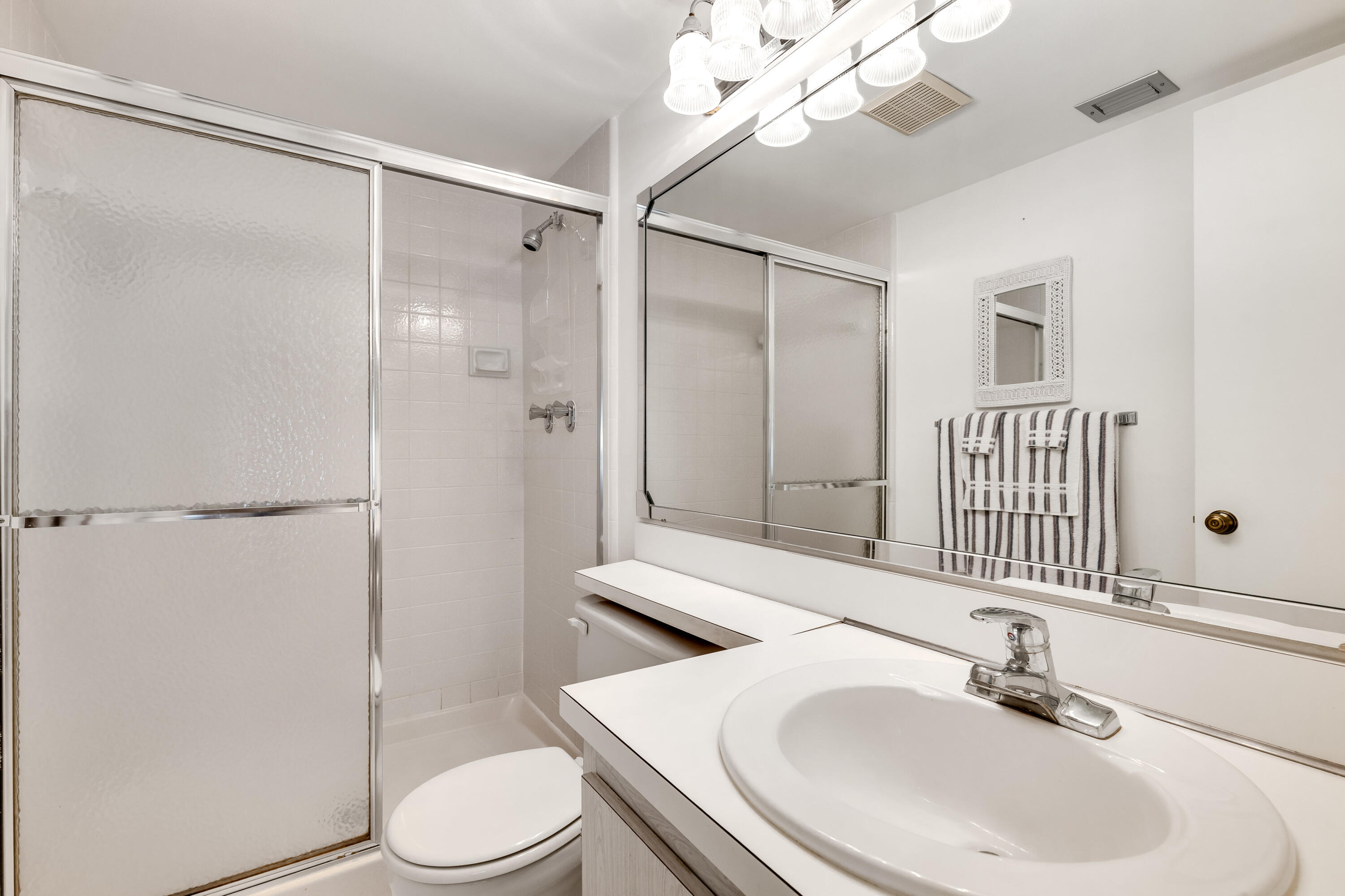 122 Lake Pine Circle, Unit B1 Greenacres, FL 33463 - Photo 23 of 36 a bathroom with a sink toilet and shower