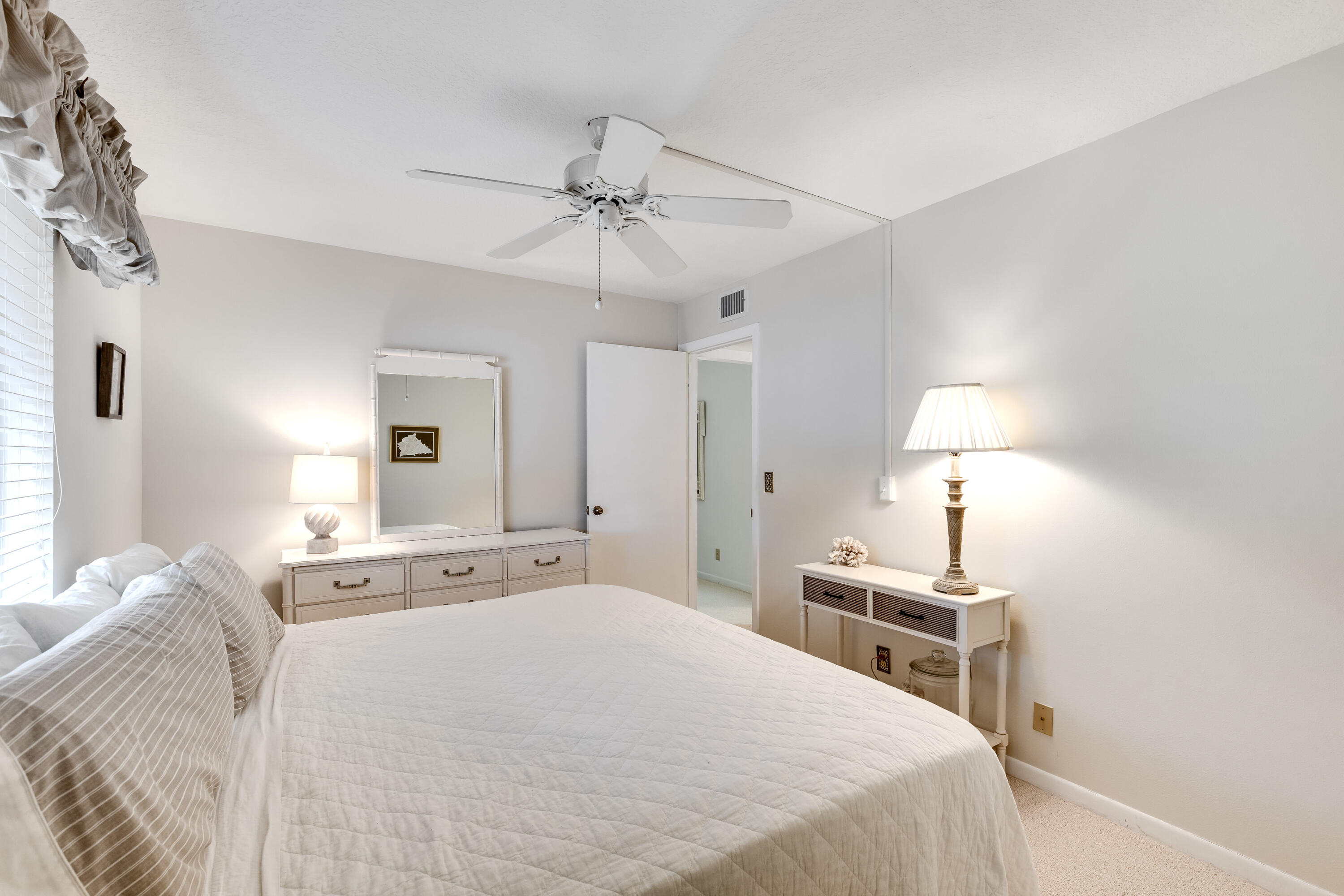 122 Lake Pine Circle, Unit B1 Greenacres, FL 33463 - Photo 26 of 36 a bedroom with a bed and a lamp