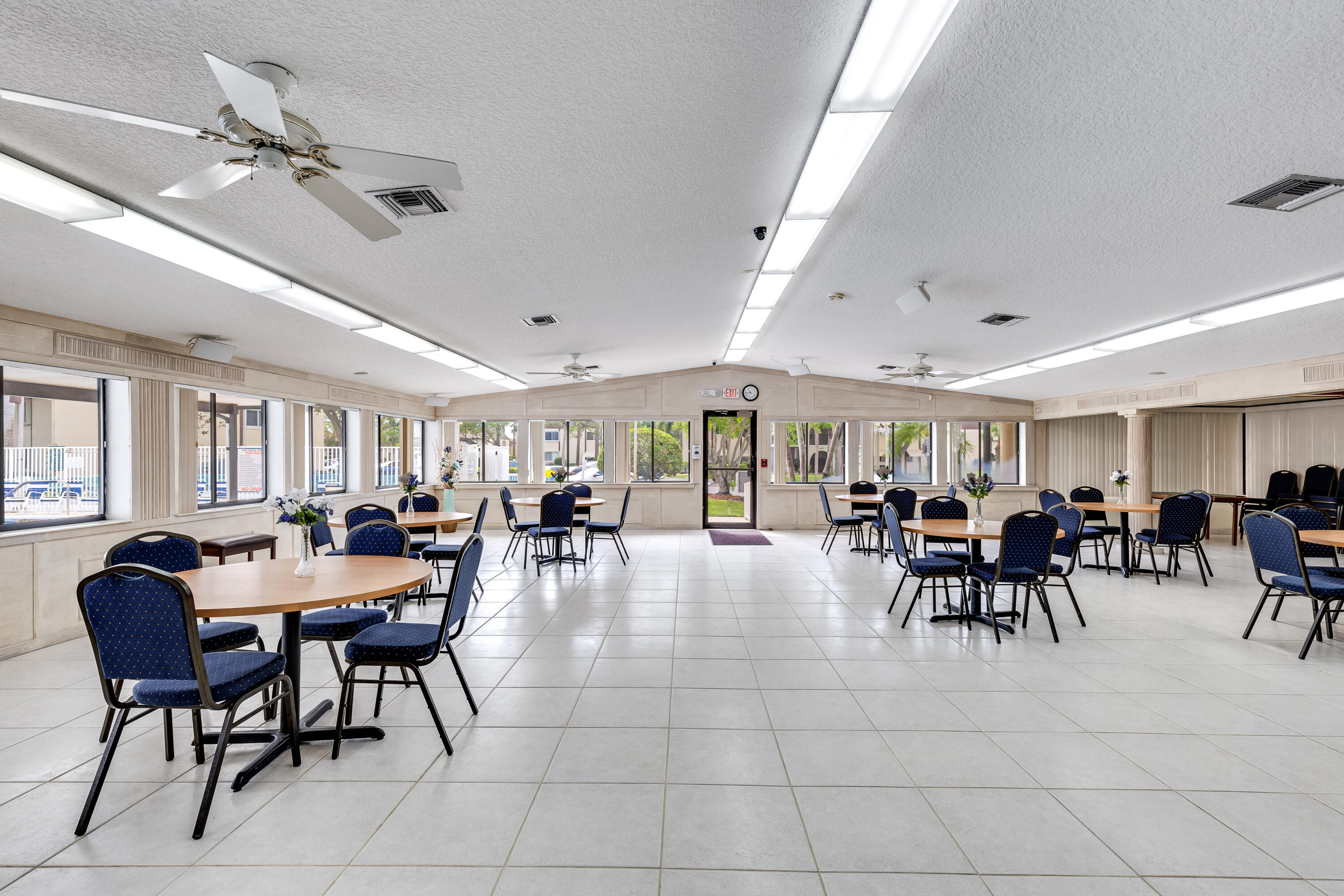 122 Lake Pine Circle, Unit B1 Greenacres, FL 33463 - Photo 31 of 36 a view of a dining room with furniture and chandelier