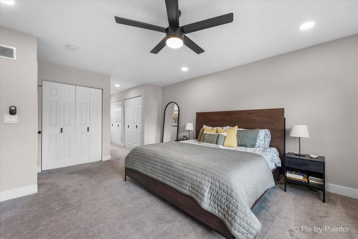 906 Edward Street Wheeling, IL 60090 - Photo 18 of 34 a bedroom with a bed and a chandelier