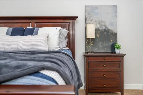 a view of bedroom with furniture and painting on the wall