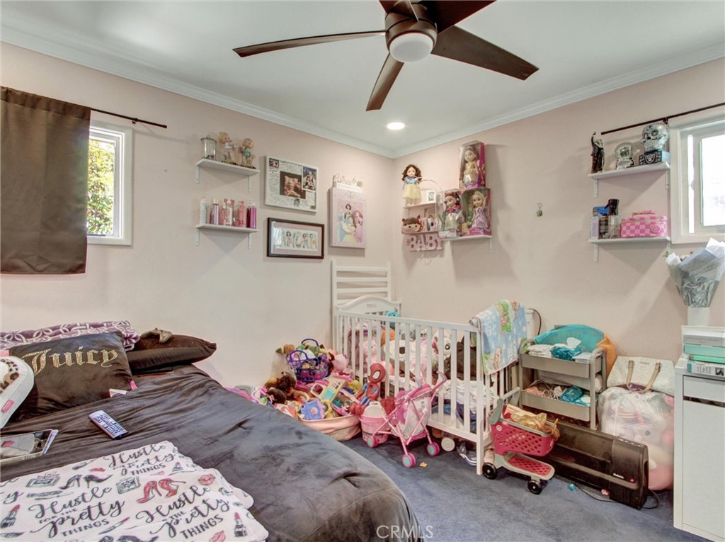 10922 Vickers Drive Garden Grove, CA 92840 - Photo 15 of 25 a bedroom with furniture and a chandelier