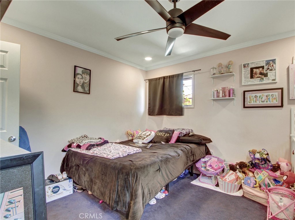 10922 Vickers Drive Garden Grove, CA 92840 - Photo 16 of 25 a bedroom with a bed and a chandelier