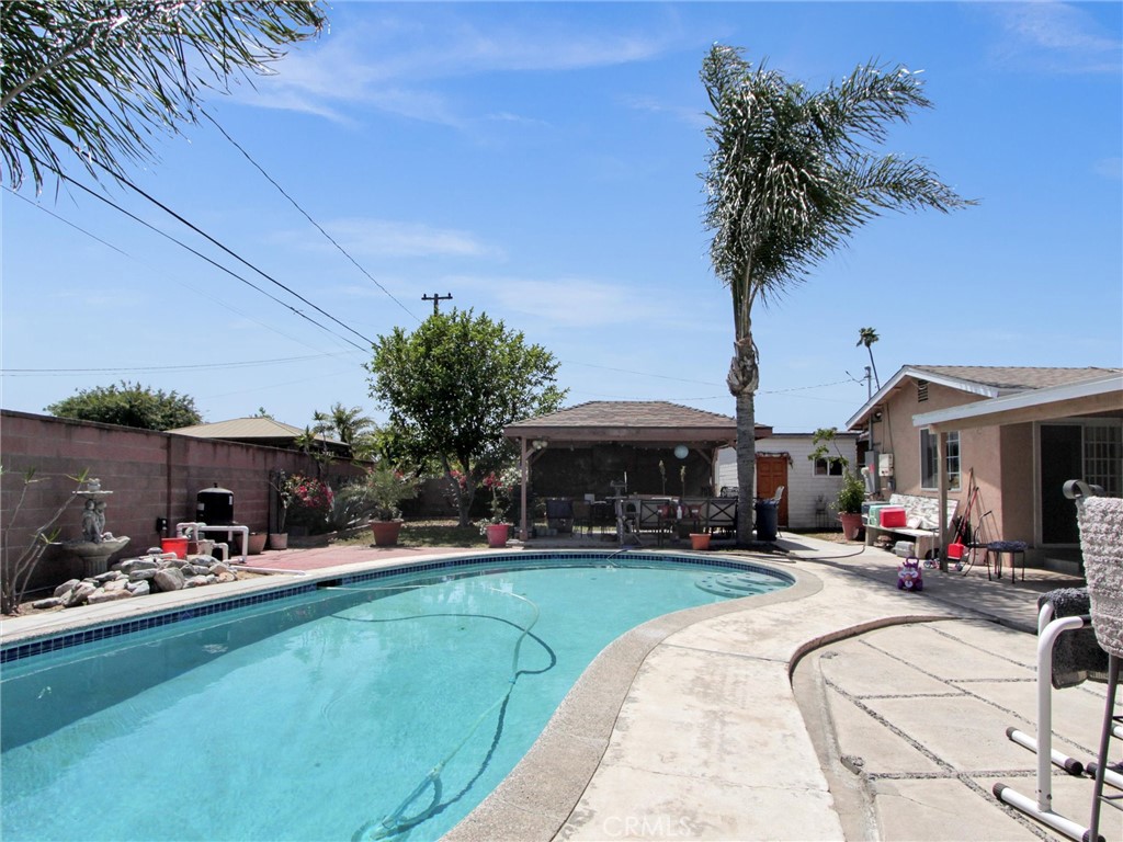 10922 Vickers Drive Garden Grove, CA 92840 - Photo 21 of 25 a swimming pool view with a seating space and a garden view