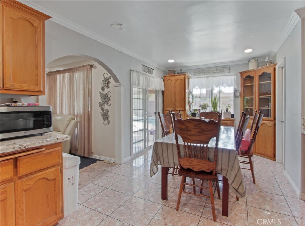 10922 Vickers Drive Garden Grove, CA 92840 - Photo 10 of 25 a view of a dining room with furniture and a kitchen