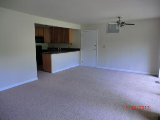 5880 Forest View Road, Unit B Lisle, IL 60532 - Photo 3 of 15 a living room with stainless steel appliances kitchen island granite countertop white cabinets and black appliances