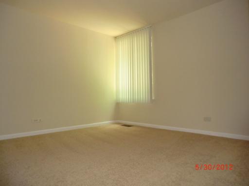 5880 Forest View Road, Unit B Lisle, IL 60532 - Photo 9 of 15 an empty room with a empty space and a window
