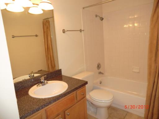 5880 Forest View Road, Unit B Lisle, IL 60532 - Photo 10 of 15 a bathroom with a sink a toilet and shower
