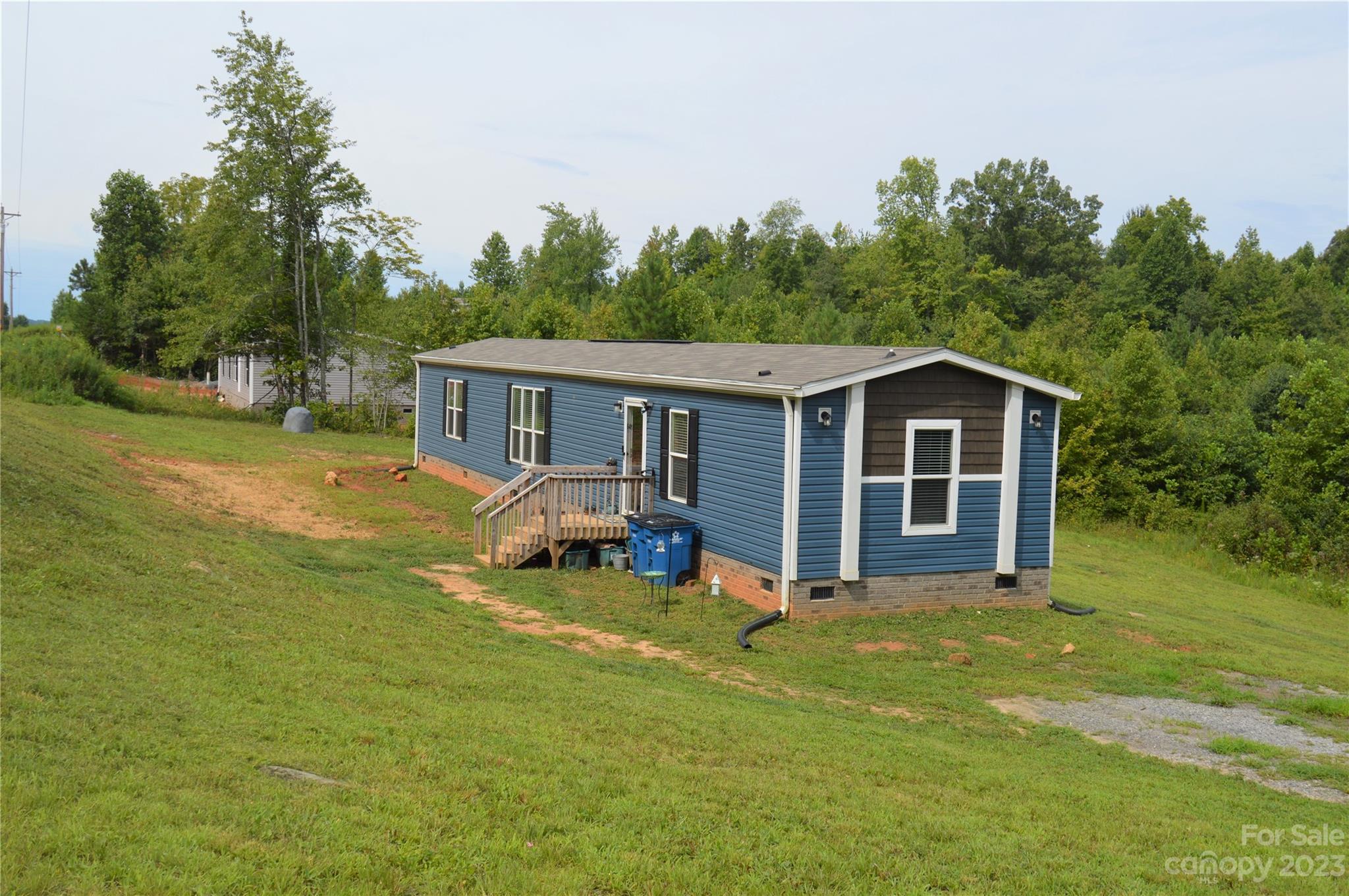 a view of a house with backyard porch and sitting area
