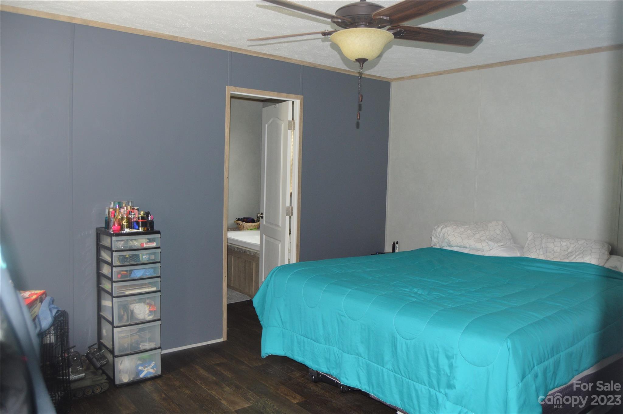 6418 Dysartsville Road Morganton, NC 28655 - Photo 14 of 20 a bedroom with a bed and a chandelier