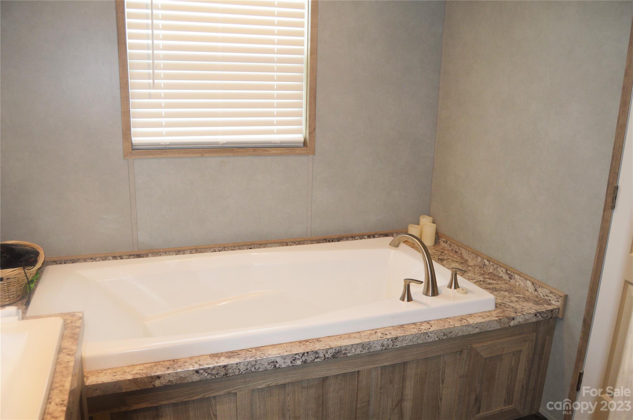 6418 Dysartsville Road Morganton, NC 28655 - Photo 16 of 20 a bathroom with a granite countertop sink and bathtub