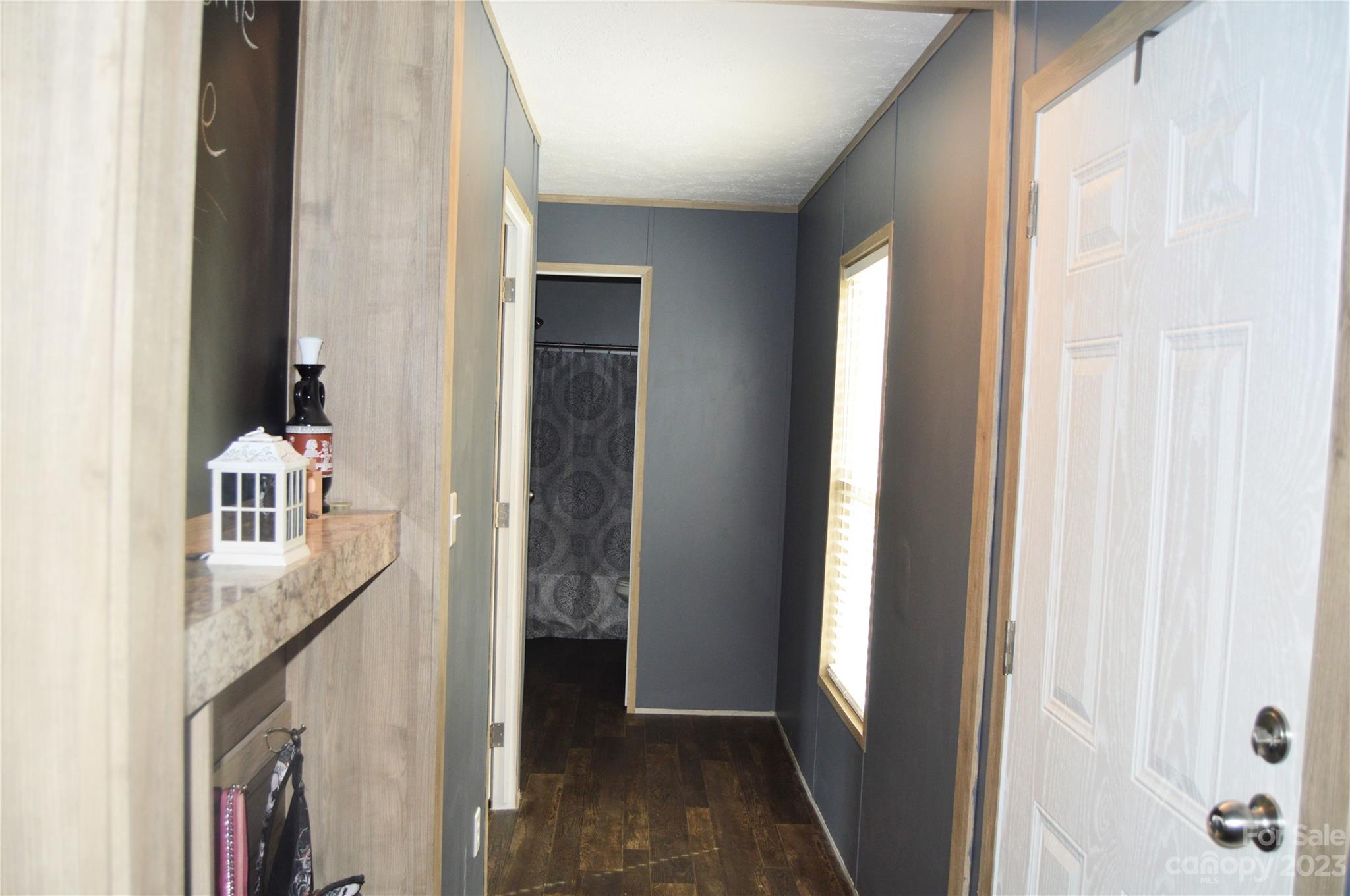 6418 Dysartsville Road Morganton, NC 28655 - Photo 17 of 20 a view of a hallway with a livingroom and a bathroom with sink