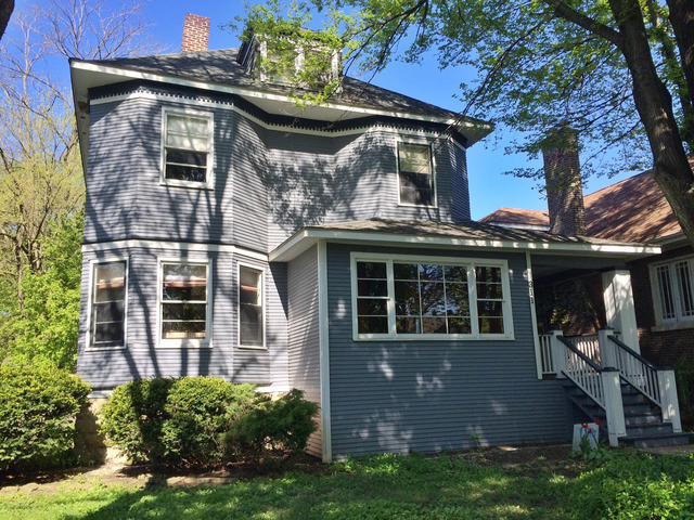 a view of a house with many windows and plants