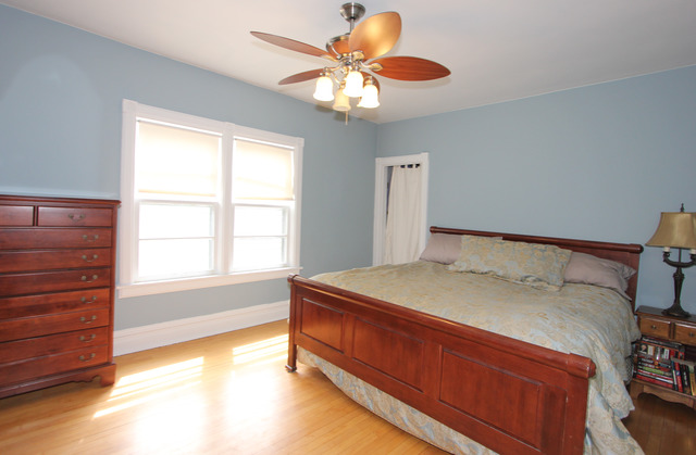 311 South Ridgeland Avenue Oak Park, IL 60302 - Photo 15 of 25 a bedroom with a bed and a chandelier