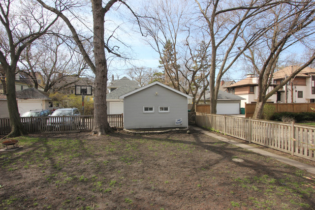 311 South Ridgeland Avenue Oak Park, IL 60302 - Photo 25 of 25 a view of a house with a large tree and wooden fence